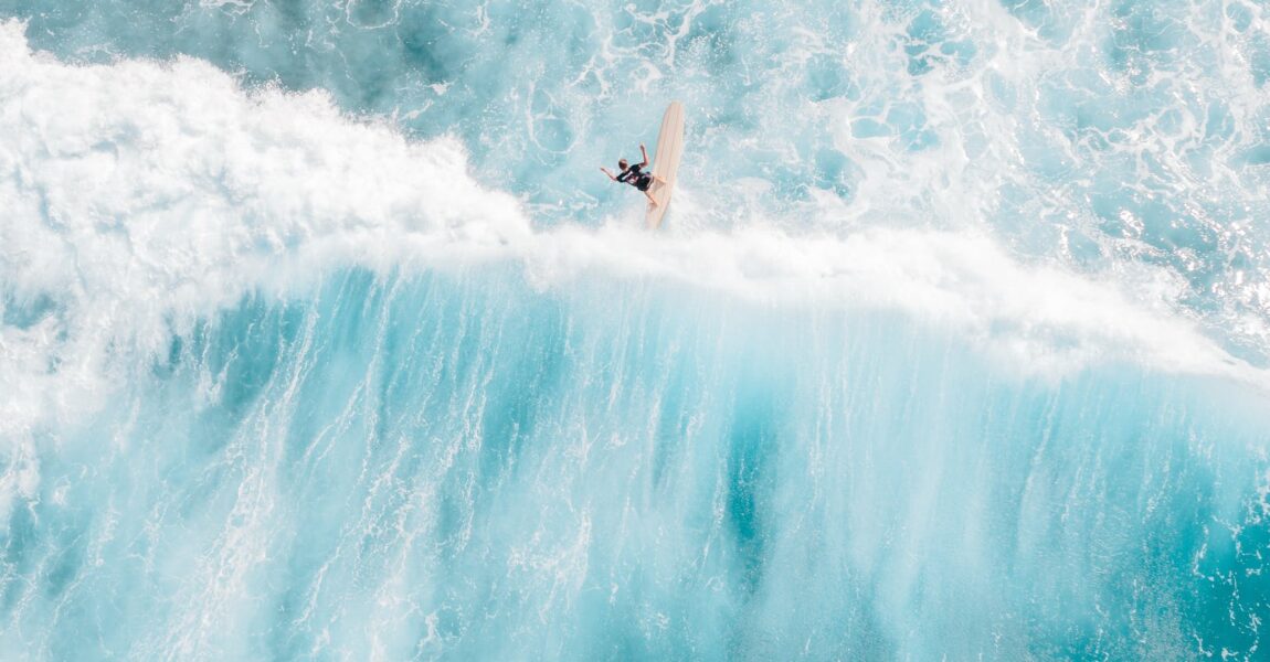 a man surfing on sea waves